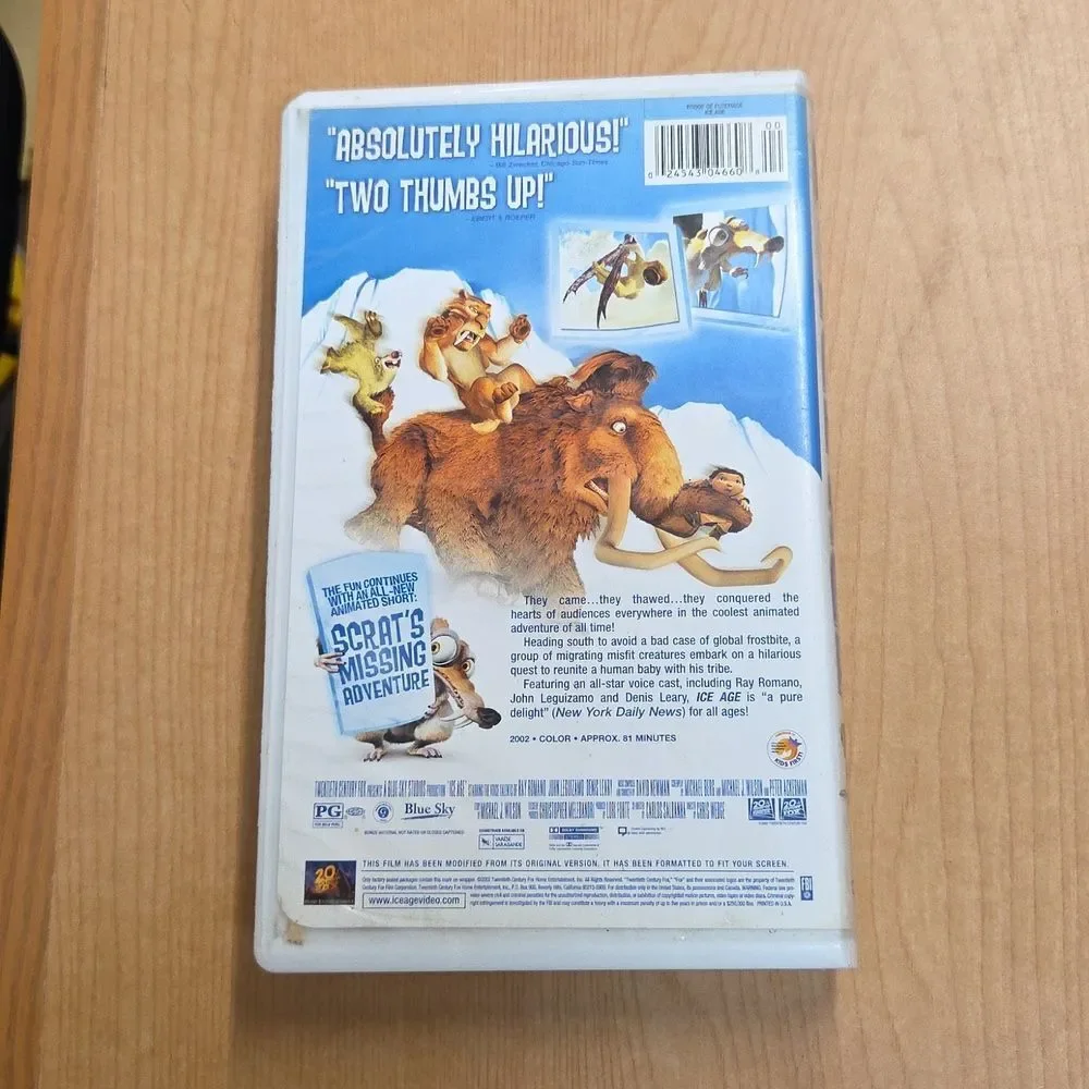 collection of Ice Age merchandise, including a VHS tape, two DVDs, Sid the Sloth